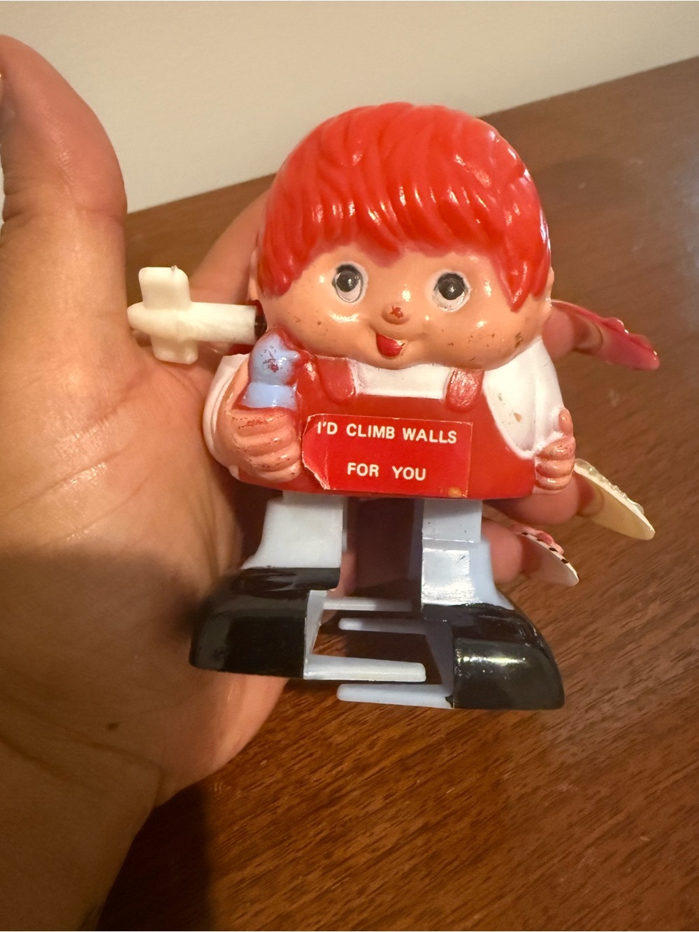 Vintage Toy Figure with 'I'd Climb Walls For You' Sign